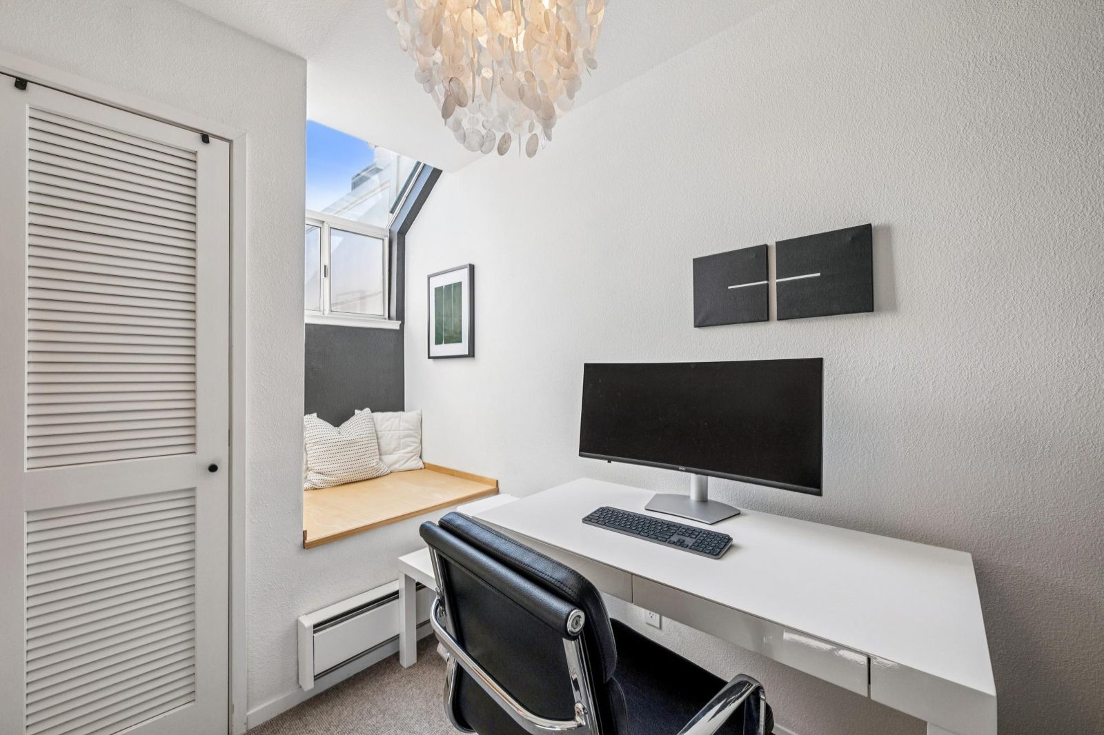 Home office with desk, window seat and skylight